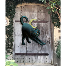 Load image into Gallery viewer, Decorative black cat sculpture on a wooden door with greenery around