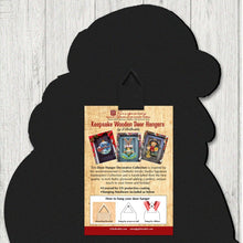 Load image into Gallery viewer, Black silhouette of a door hanger with promotional text on a wooden surface