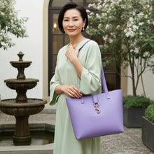 Load image into Gallery viewer, Woman_carrying_purple_pebbled_leather_tote_bag_as_a_shoulder_bag