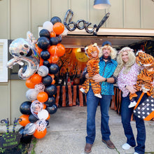 Load image into Gallery viewer, Family with children in tiger costumes standing in front of a decorated truck for Halloween.