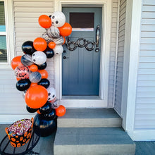Load image into Gallery viewer, Halloween-themed balloon arch on a front porch with candy basket.