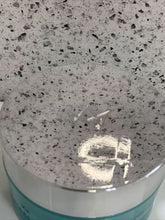 Load image into Gallery viewer, Speckled countertop with a circular object on top