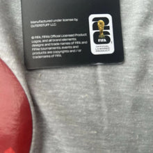 Load image into Gallery viewer, FIFA licensed product label on a gray shirt with red accents
