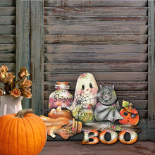 Load image into Gallery viewer, Halloween-themed decorations including a ghost, potion bottles, and pumpkins against a wooden background.
