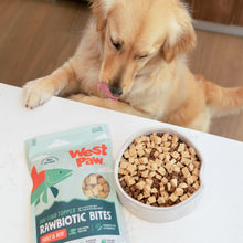 Load image into Gallery viewer, Golden retriever beside a bowl of kibble topped with Rawbiotic Bites dog food topper

