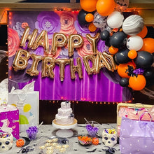 Load image into Gallery viewer, Halloween-themed birthday party setup with balloons, cake, and decorations.
