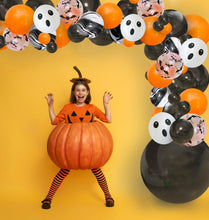 Load image into Gallery viewer, Child in a pumpkin costume with Halloween-themed balloons on a yellow background
