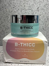 Load image into Gallery viewer, B-Thicc booty enhancing mask with packaging on a speckled gray surface
