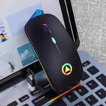 Load image into Gallery viewer, Gaming mouse with RGB lighting on a laptop keyboard
